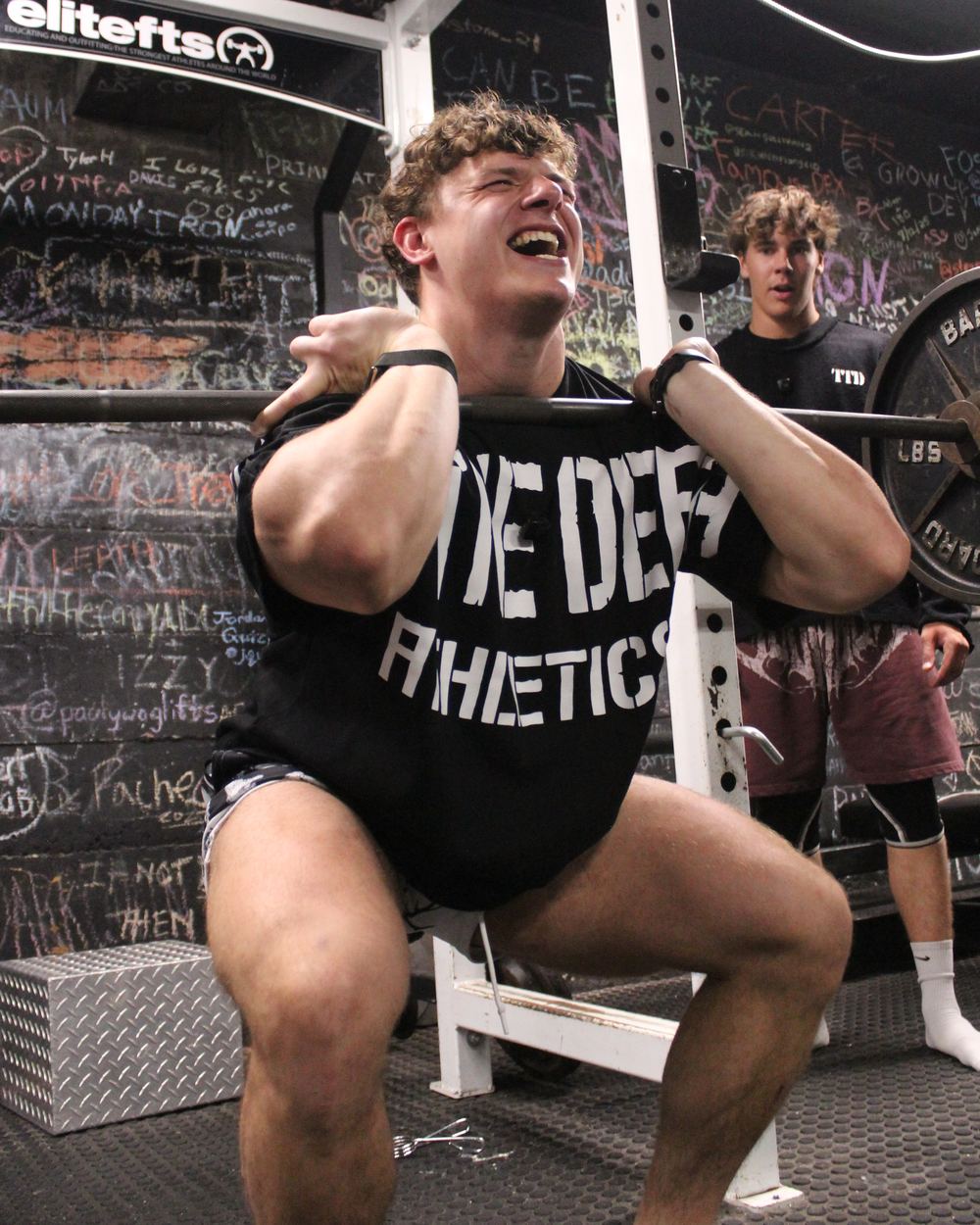 CJ Fazio at the bottom of a heavy front squat, elbows up